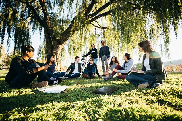 ANU students sitting on the grass