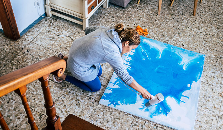 woman making a painting at home